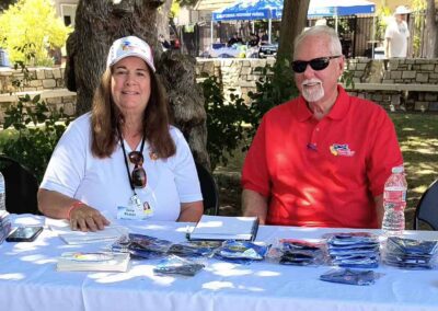 Volunteers manning an outreach table, sharing information.